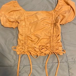 Orange ruched bow tie top